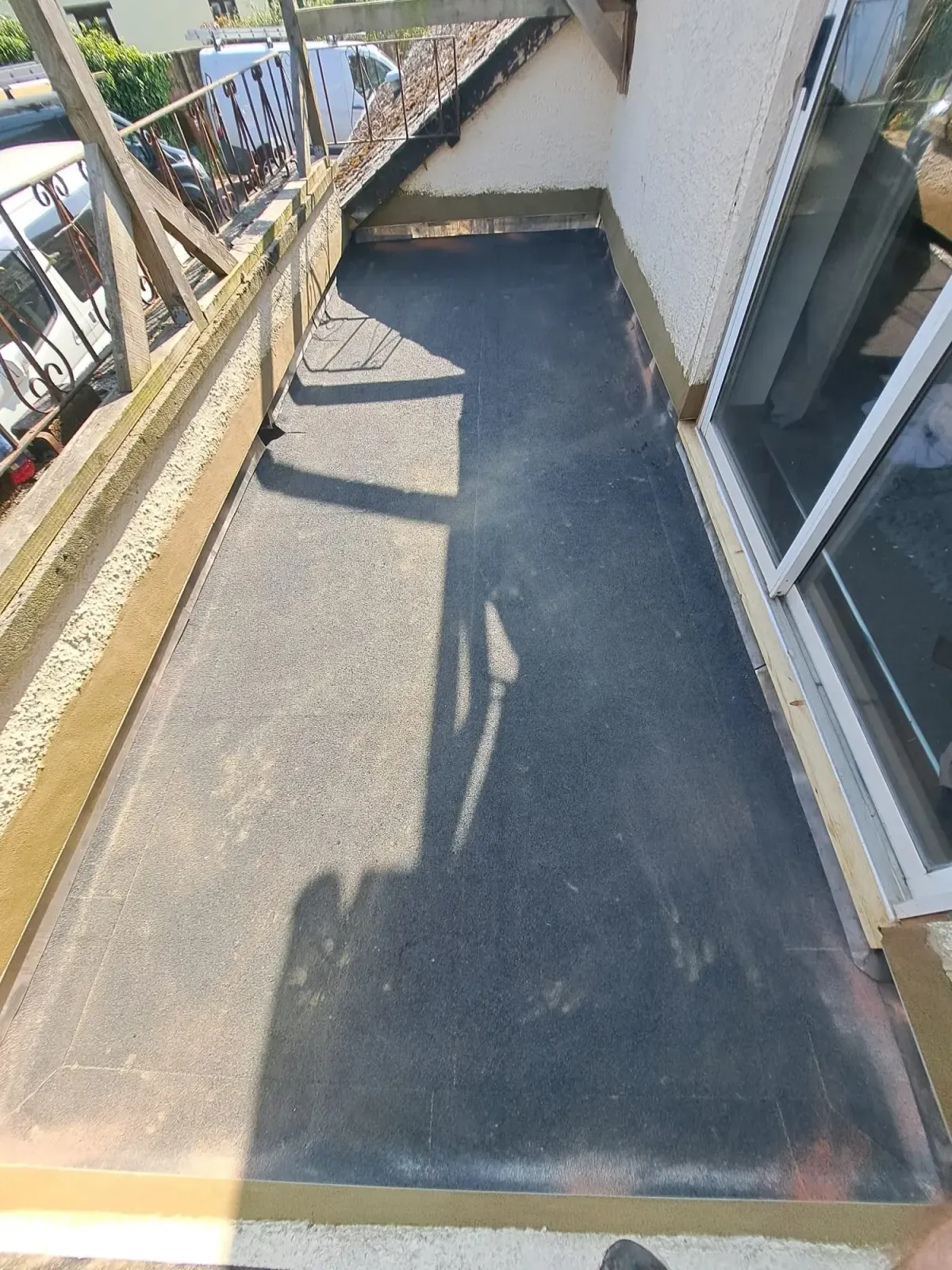 Mineral felt flat roof laid over a balcony area with a timber edge trim