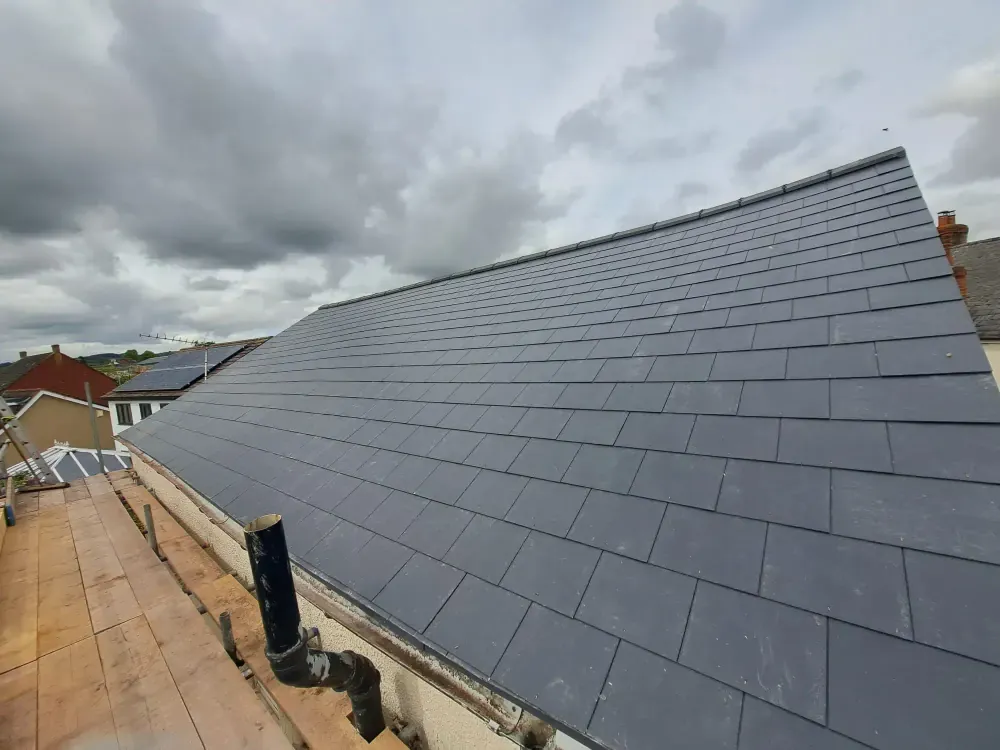 New slate roof covering a bungalow, seen along the ridge