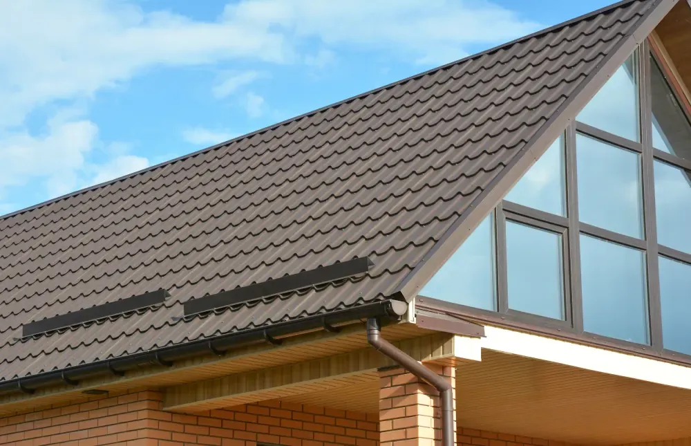 Tiled roof meeting the glazed gable of a property in Devon