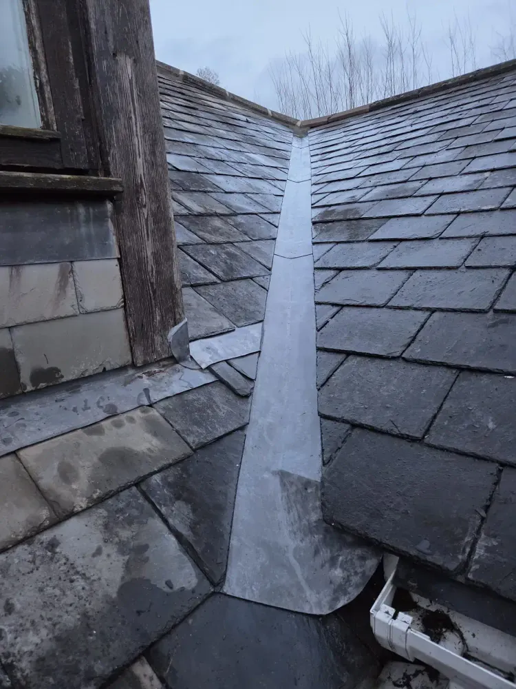 Lead-lined valley running between two slated roof slopes